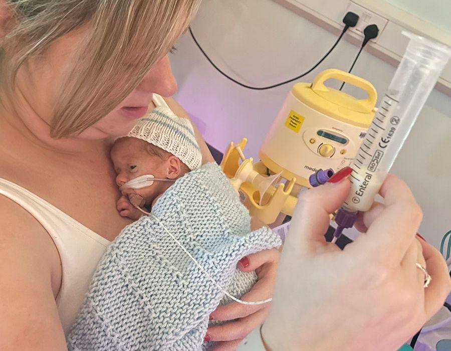 Mum holding her premature baby skin to skin on the neonatal unit