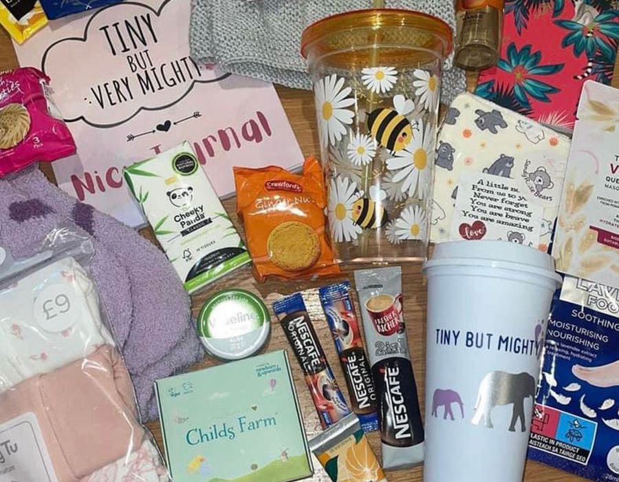 Tiny But Mighty care pack with snacks, hot drinks, toiletries, socks and a branded travel cup
